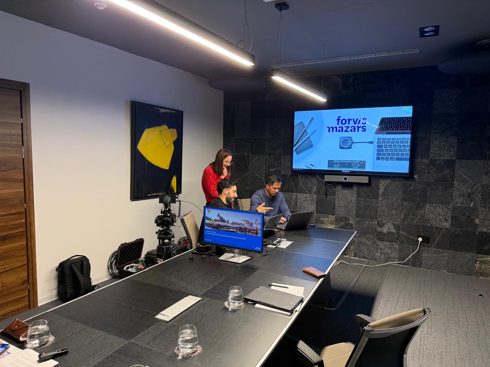 Setting up the webinar — testing equipment and slides in the conference room