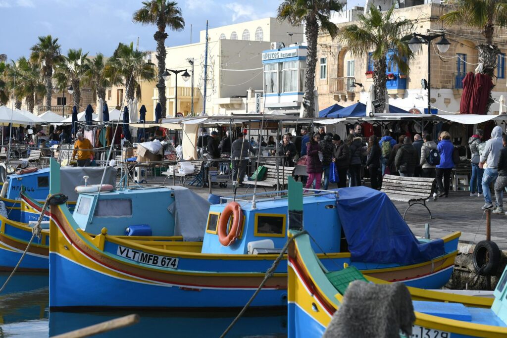 marsaxlokk sunday market, fisher boats in front, malta